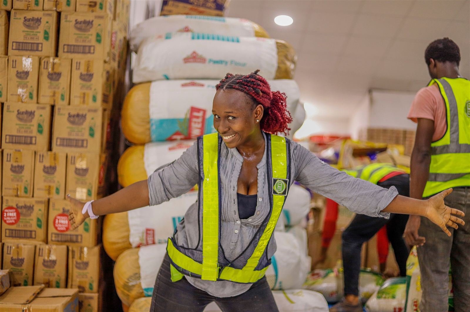 A Belleza warehouse team member among stacked partner-brand stock